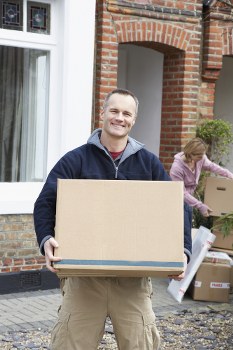 Moving team carrying boxes safely during a house relocation