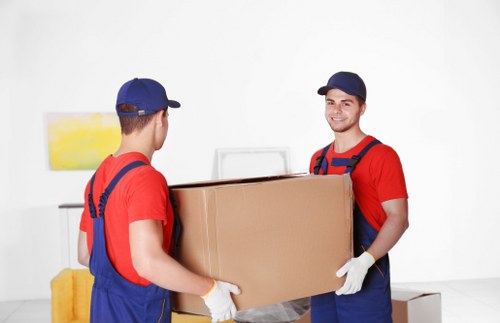 Furniture being carried through a Lambeth flat staircase